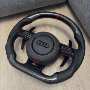 This is a custom carbon fiber and leather flat-bottom steering wheel designed for various Audi models, featuring red stitching and a matching top